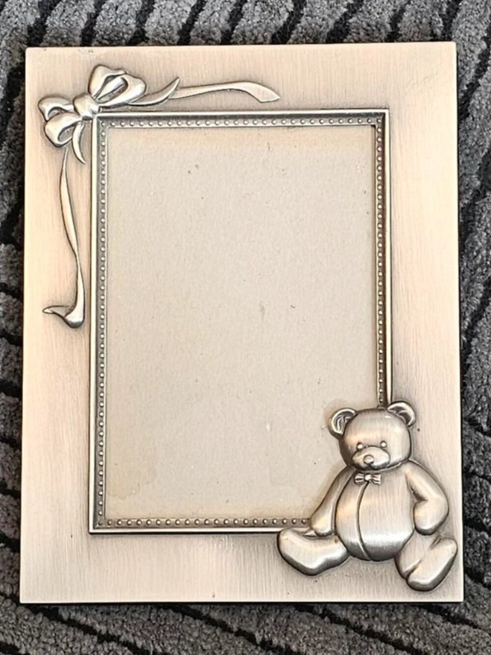 Vintage silver picture frame with teddy bear and bow design